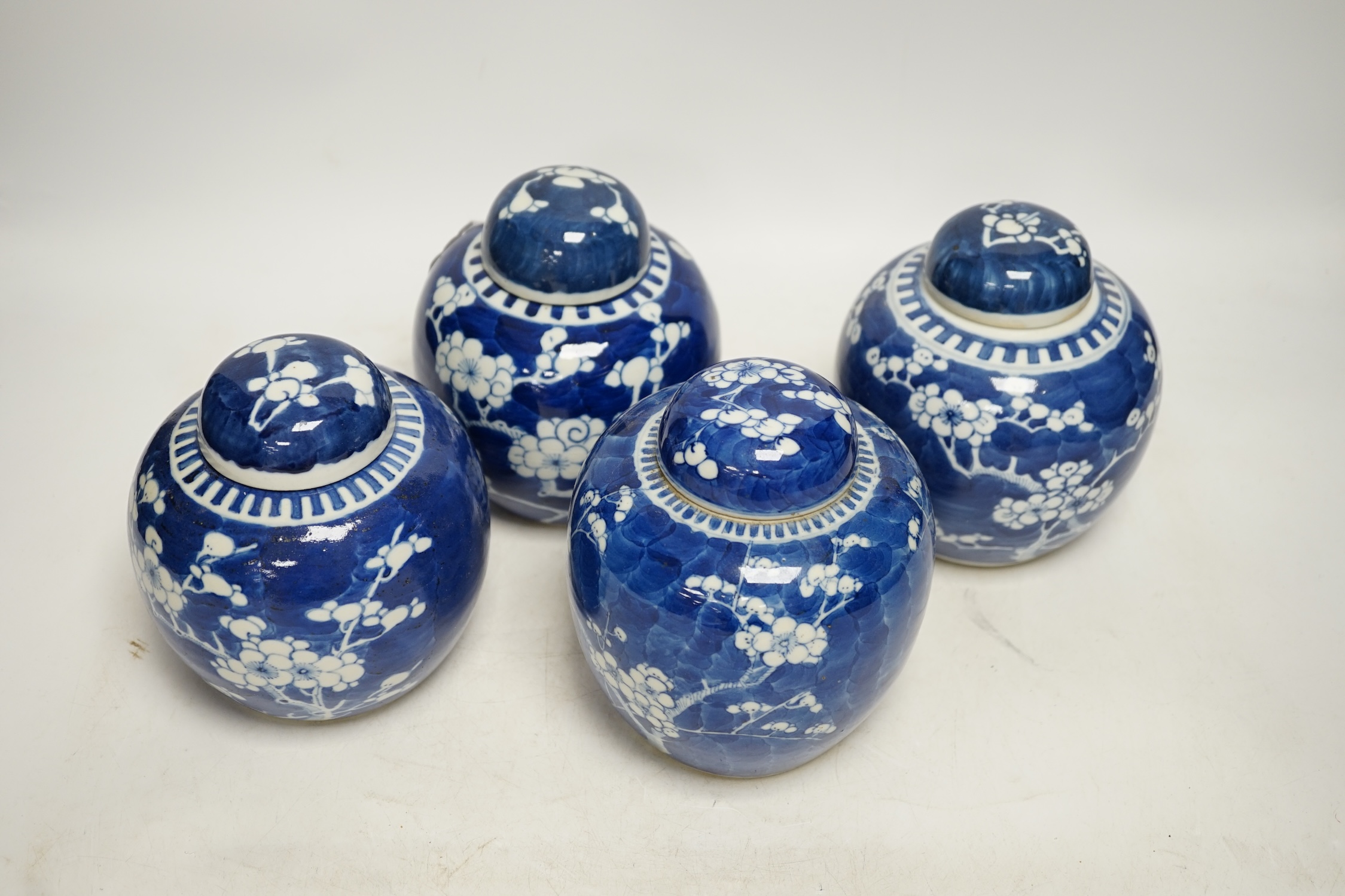 Four Chinese blue and white prunus jars and covers, tallest 15cm high. Condition - good